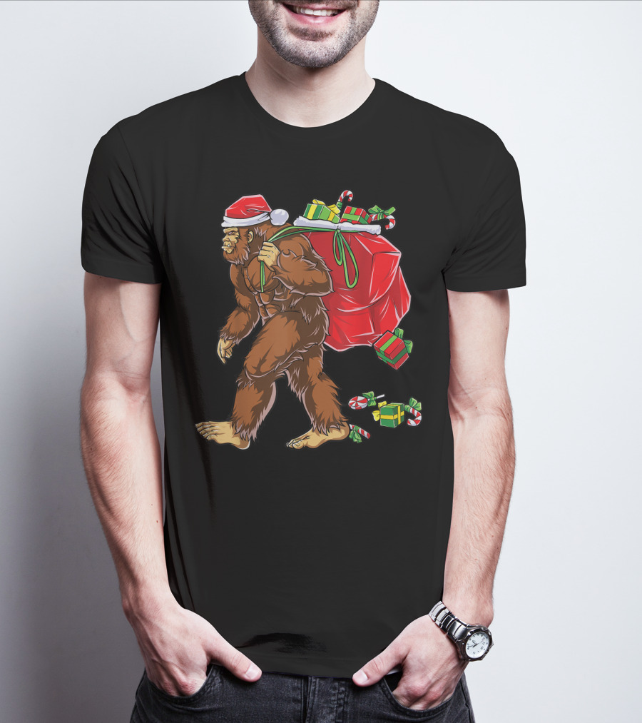 Bigfoot Santa With Giant Red Christmas Bag And Green Gifts Wearing Xmas Hat T-Shirt