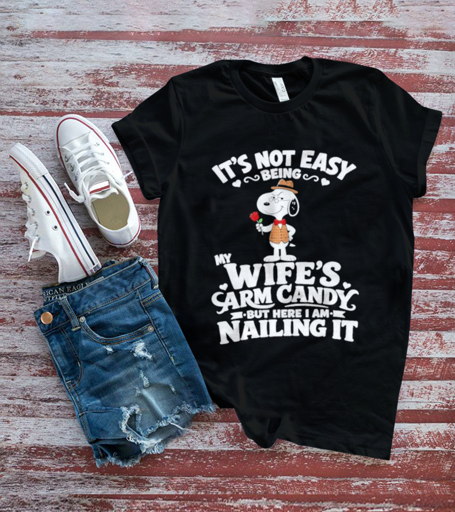Snoopy It's Not Easy Being My Wife's Arm Candy But Here I Am Nailing It T-Shirt