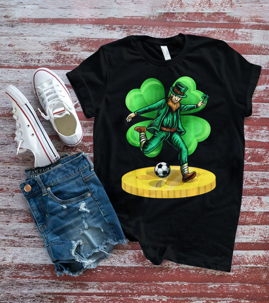 Leprechaun Kicking Soccer Ball On Gold Coin With Shamrock Background T-Shirt