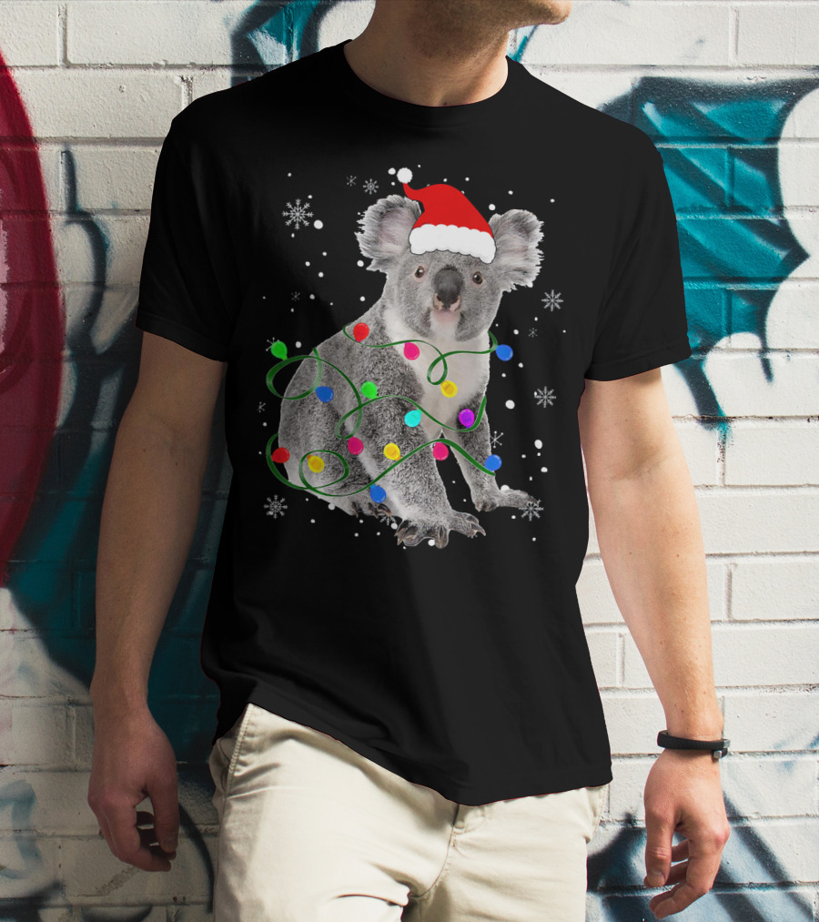 Koala Wrapped In Christmas Lights Wearing Santa Hat With Snowflakes Matching Fam T-Shirt