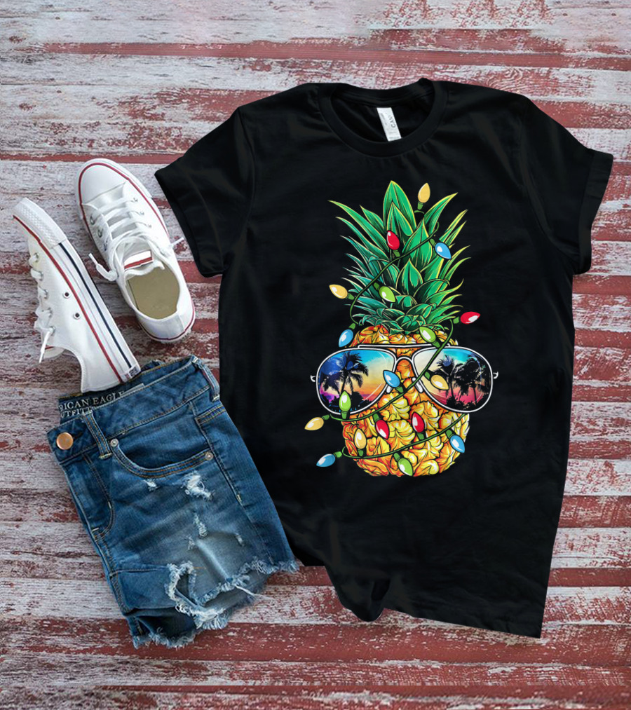 Pineapple Wrapped In Christmas Lights With Sunglasses Reflected Sunset And Palm Trees T-Shirt