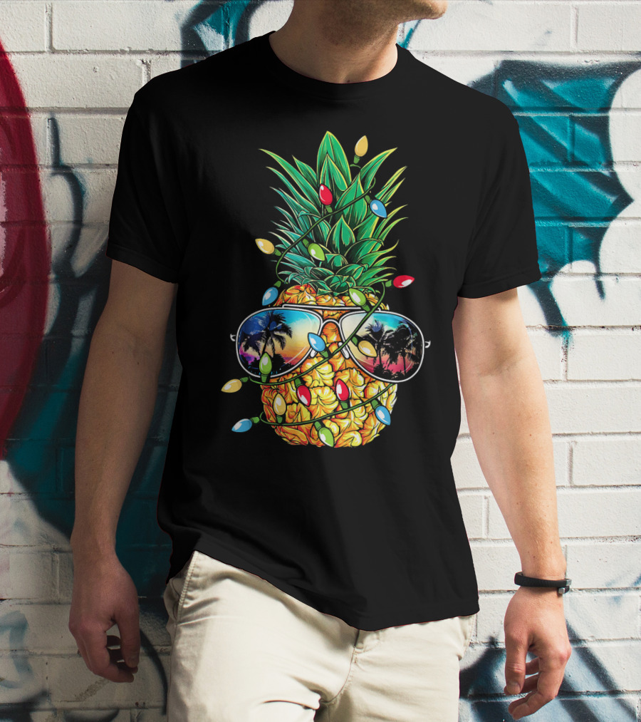 Pineapple Wrapped In Christmas Lights With Sunglasses Reflected Sunset And Palm Trees T-Shirt