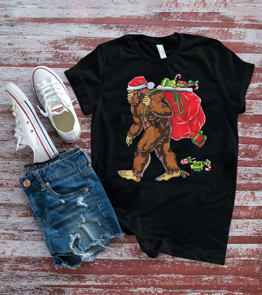 Bigfoot Santa Hat Carrying Christmas Presents And Candy Canes T-Shirt