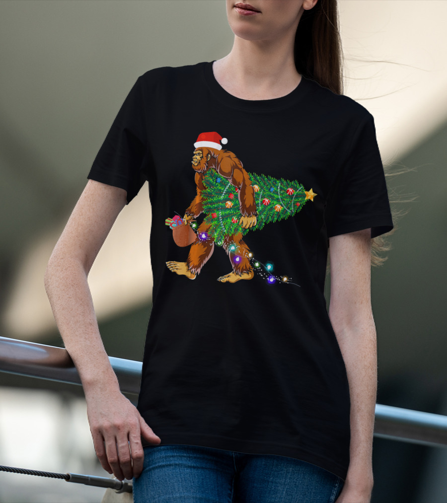 Santa Hat Bigfoot Holding Christmas Tree With Lights And Gifts T-Shirt