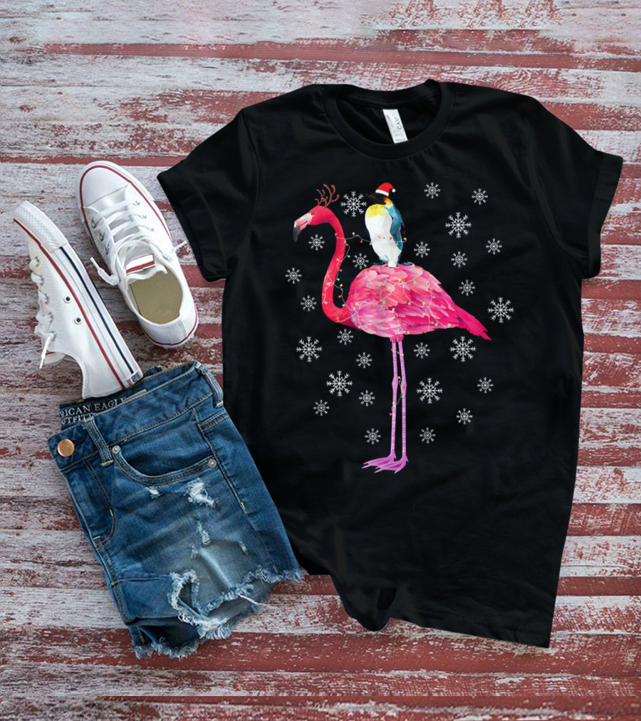 Penguin With Santa Hat Riding Flamingo With Antlers Surrounded By Snowflakes T-Shirt